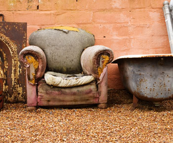 old armchair and bath outside property